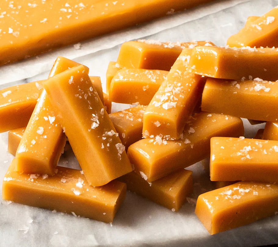 Sea salt caramels stacked on parchment