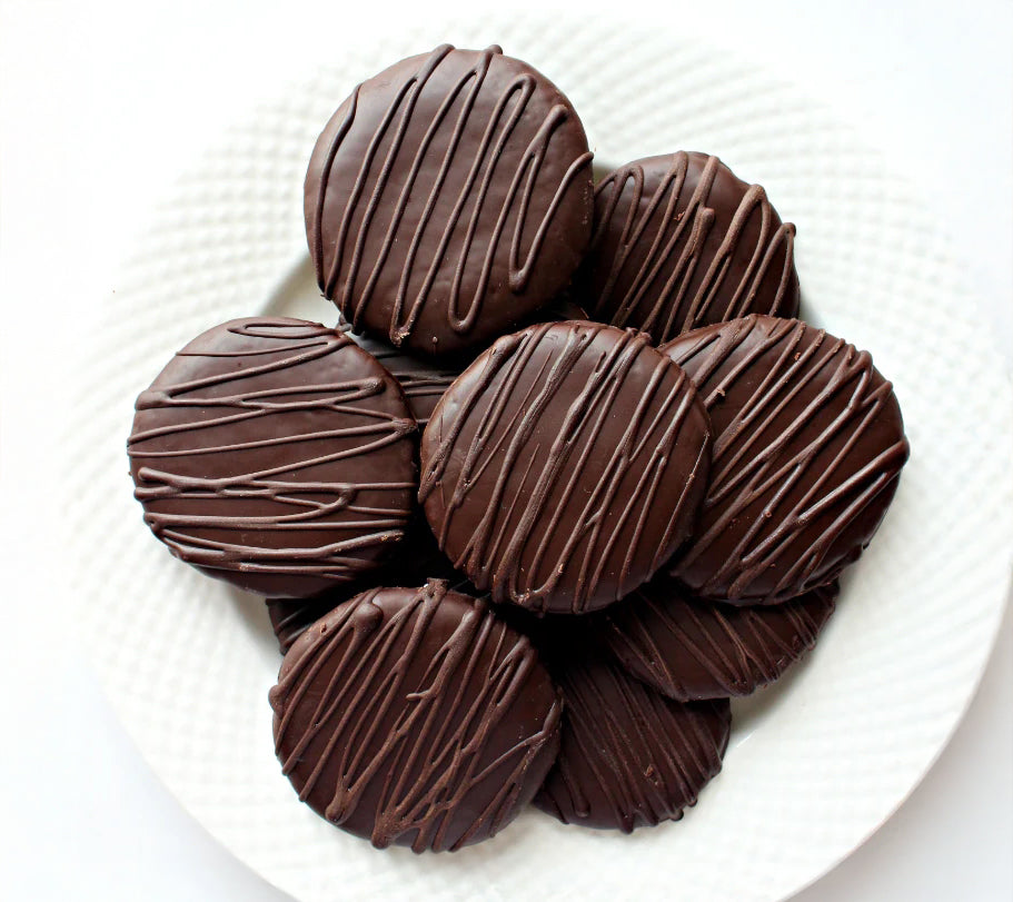 Chocolate covered caramels on a white plate