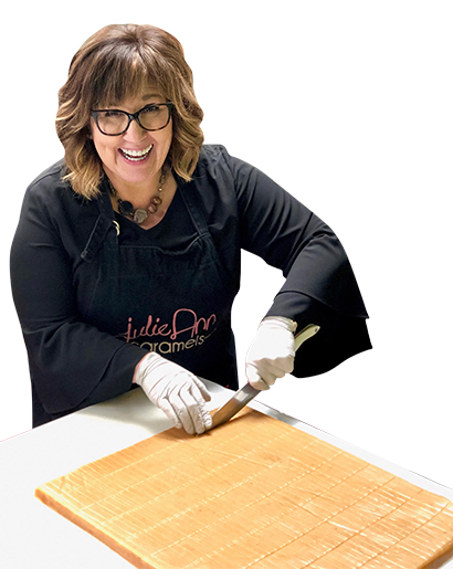 Rowena Montoya cutting a slab of caramel