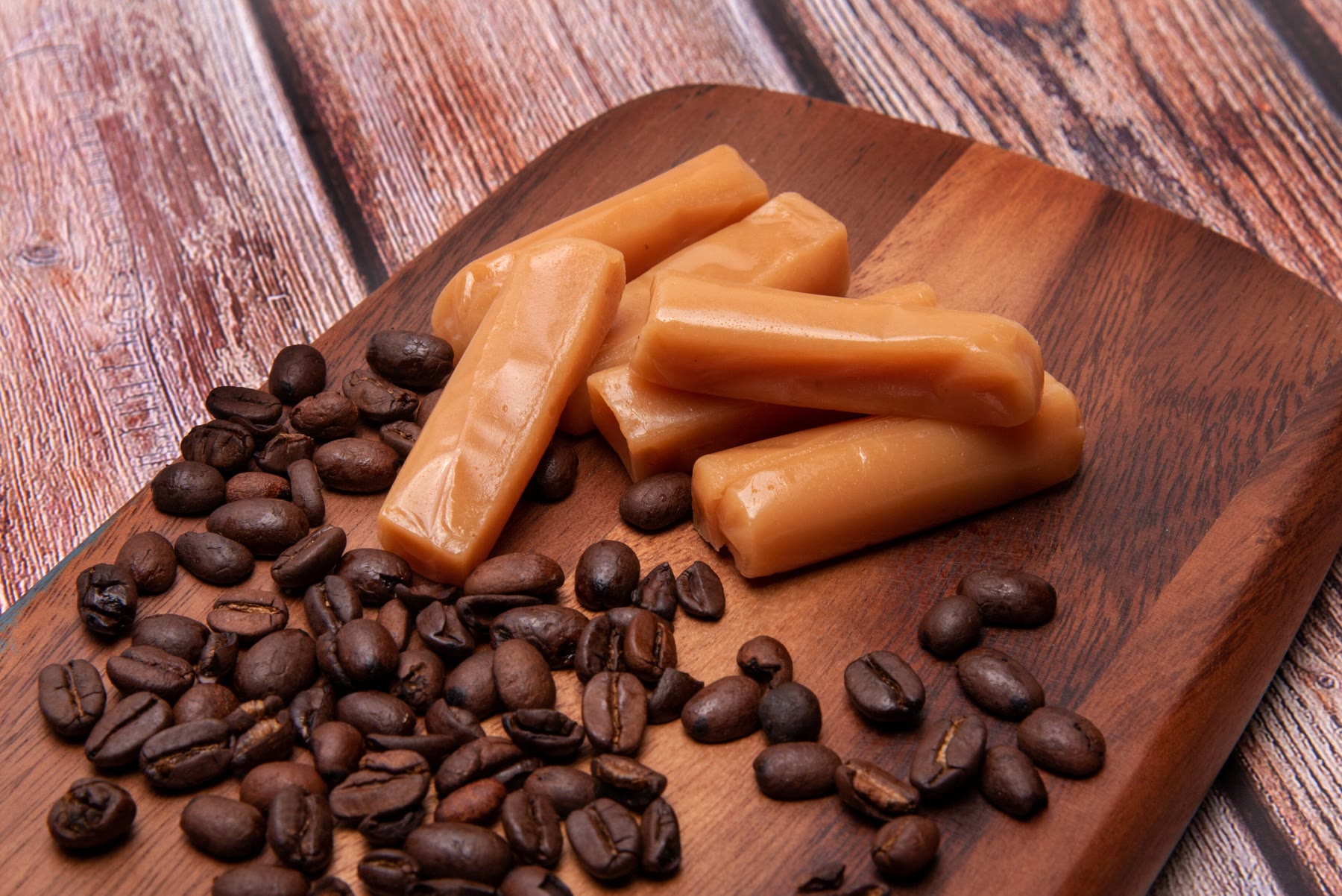 Daily Rise Coffee caramels on a wooden board with coffee beans